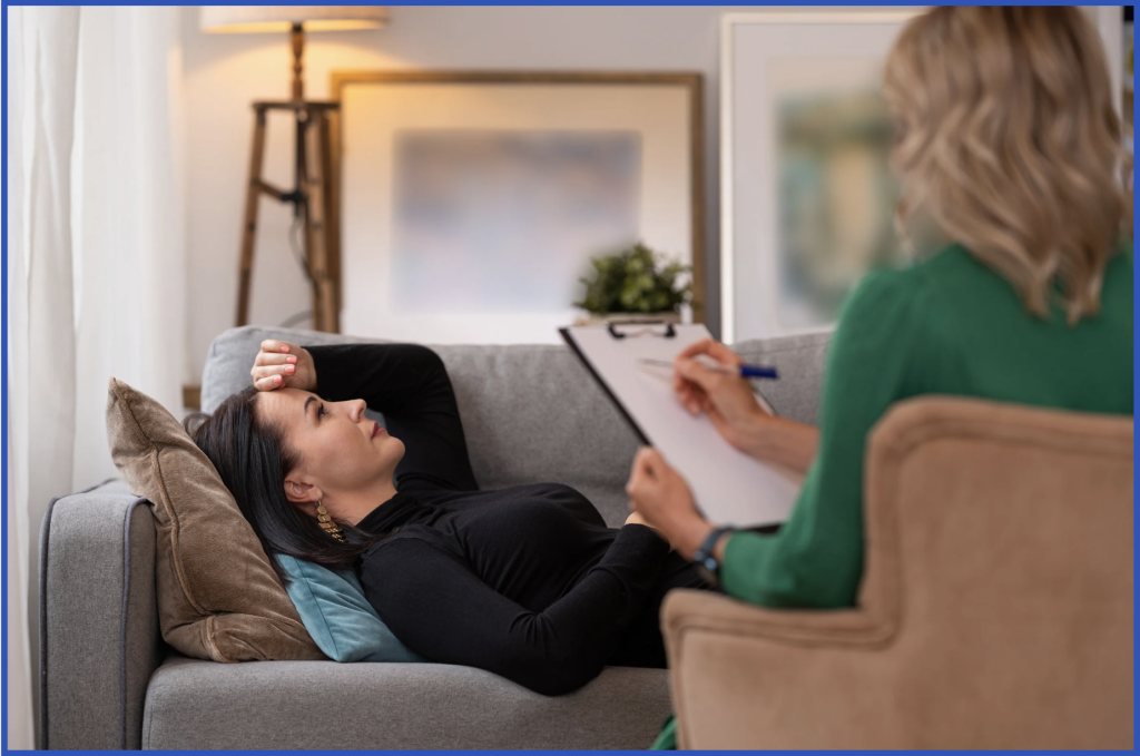 Trauma-informed therapist listening with empathy in safe therapy environment.