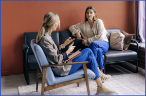 Trauma-informed therapy session showing therapist supporting client in a safe and calm space.