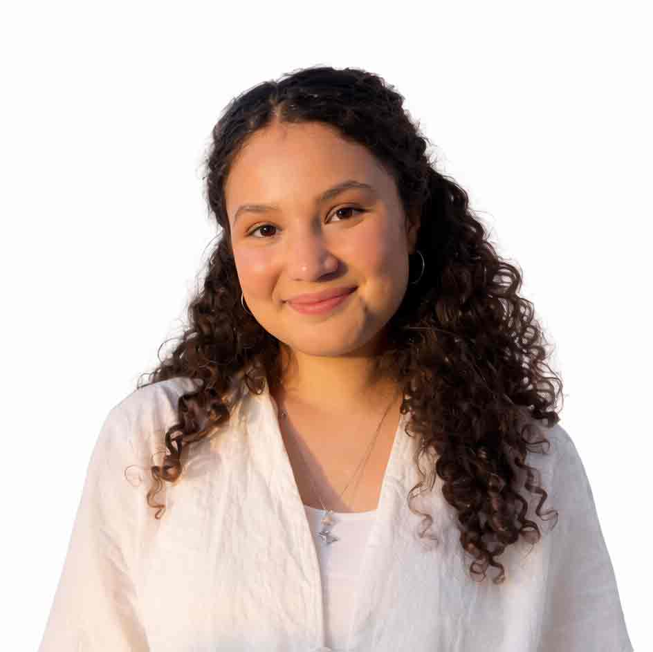 Sarah Hassam, Therapist at Gowthorpe Therapists, smiling in a white blouse against a light background.
